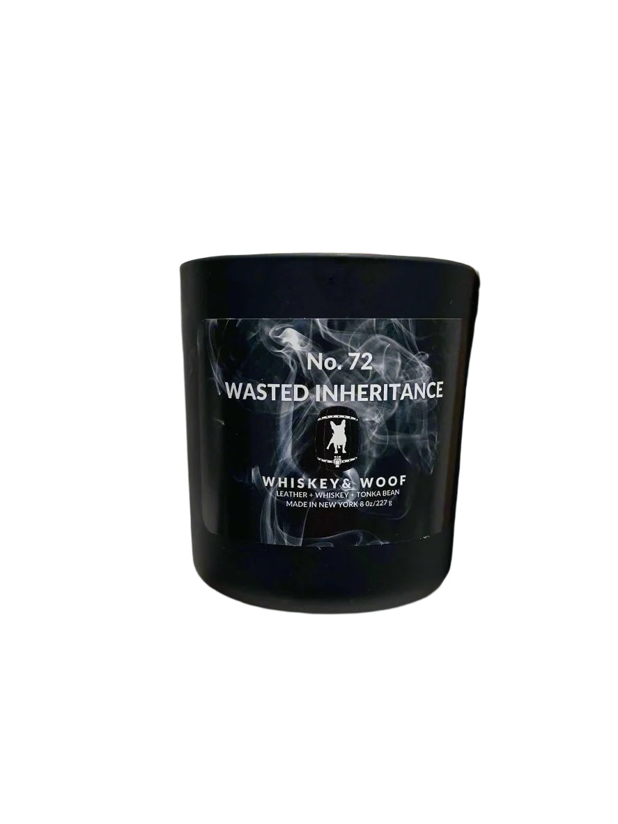 Wasted Inheritance Leather & Whiskey Candle on a gold ledge made by Whiskey & Woof